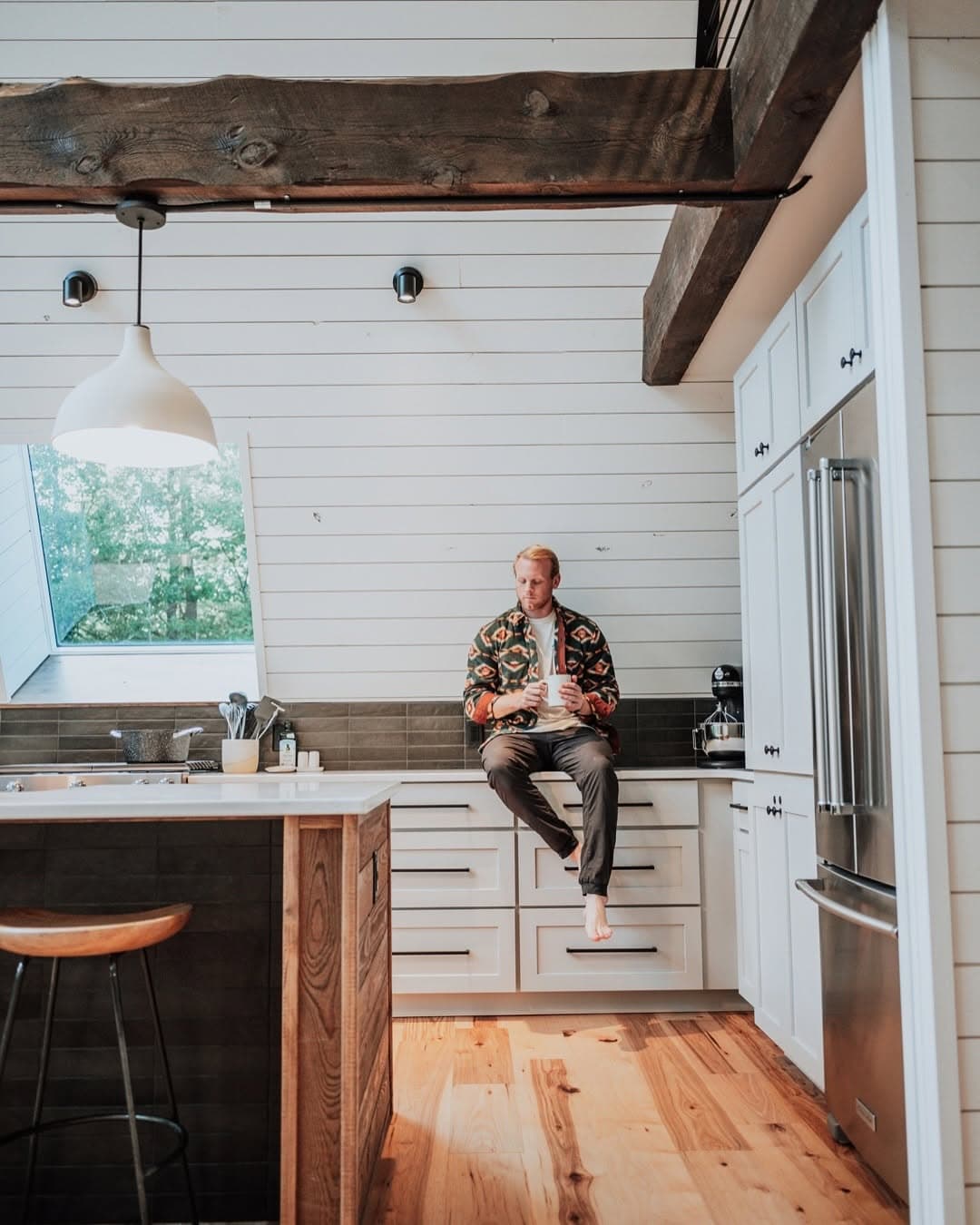 Tyler sitting in a cabin kitchen