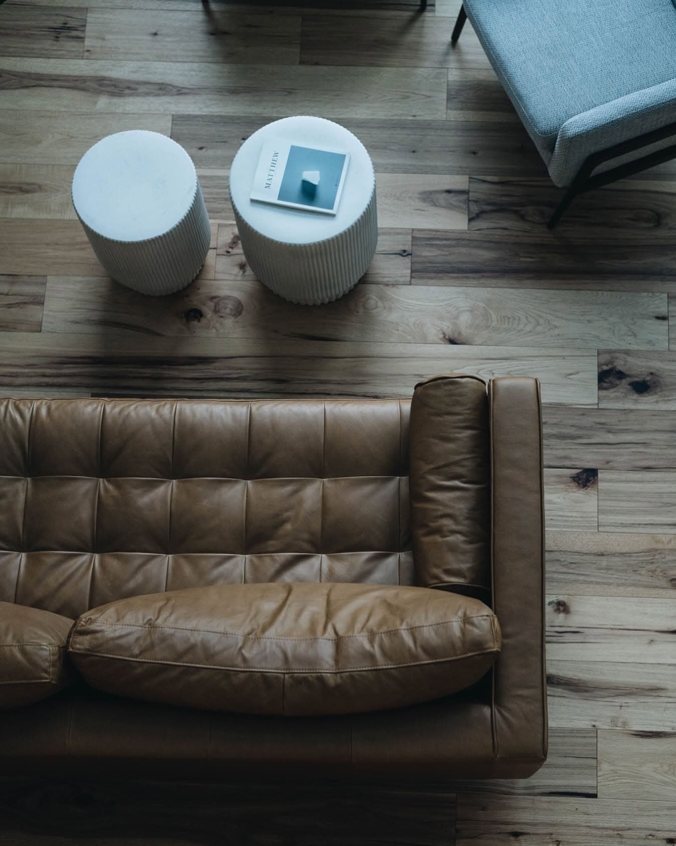 Overhead view of modern cabin interior with leather sofa and wood flooring
